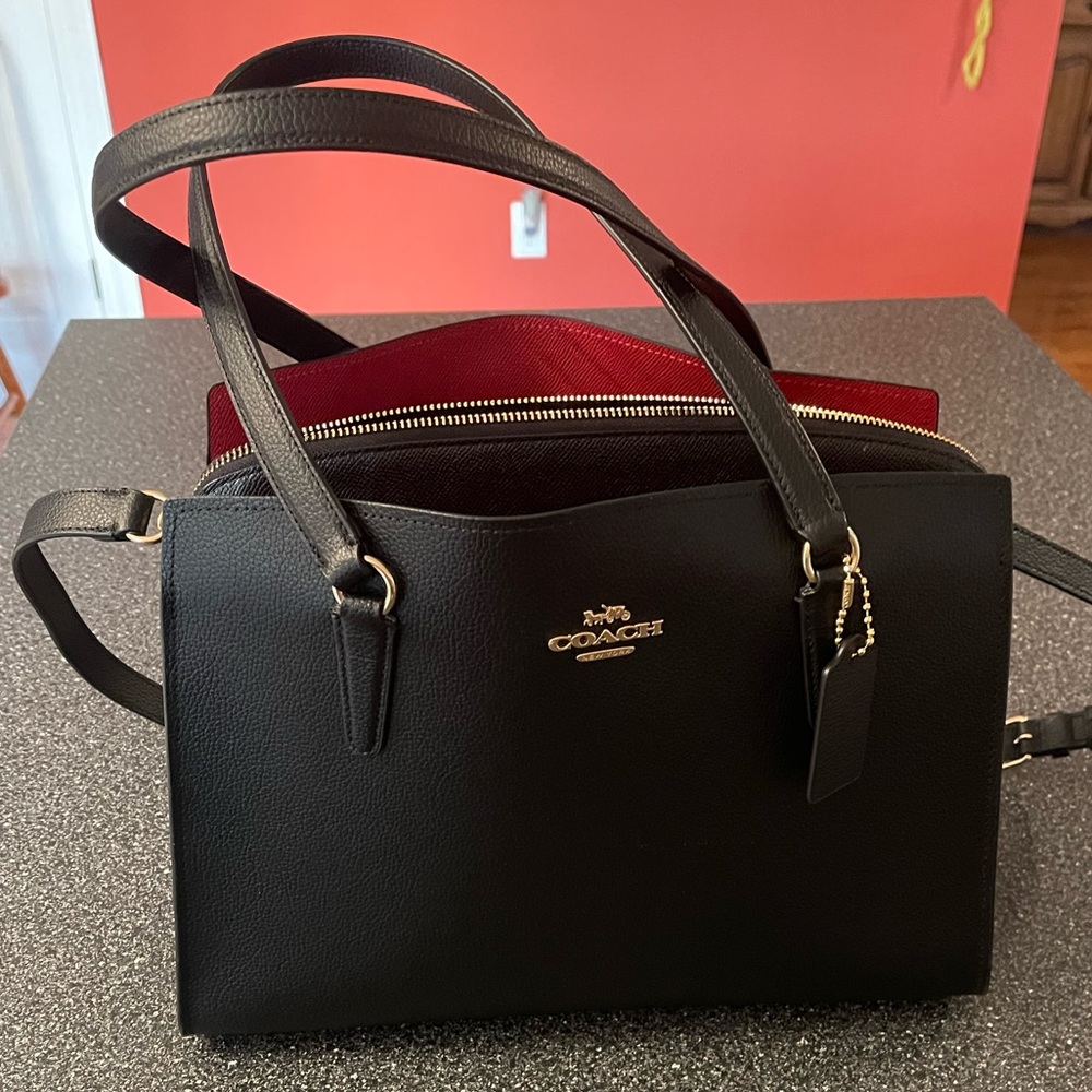 EUC Coach black handbag, with red lining. Three compartments, center zip.